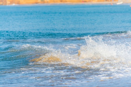 Waves of crystal clear and turquoise water on the beach in summer