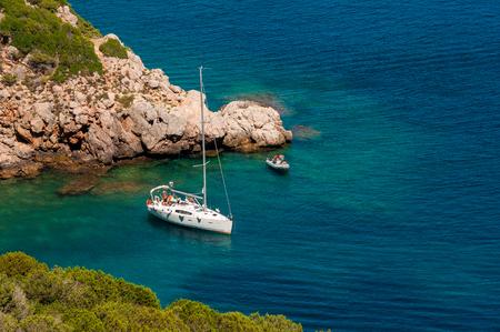 Landscape of sardinian coast with moored boatsの写真素材
