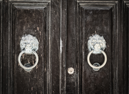 detail of an old handle on a wooden doorの写真素材