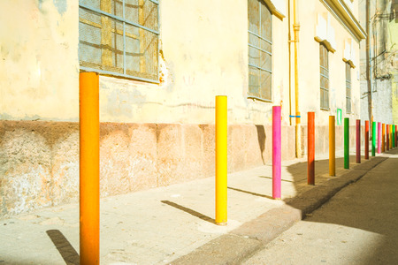 barrier made with colored poles in an alley in the sardinian city of Sassariの写真素材