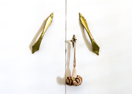 Closeup of old handle of a italian white furnitureの写真素材