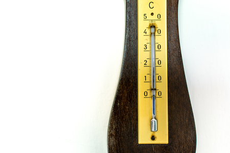 Closeup of isolated old barometer on white wall