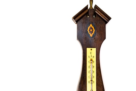 Closeup of isolated old barometer on white wallの写真素材