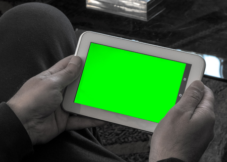 Man using a tablet with green screenの写真素材