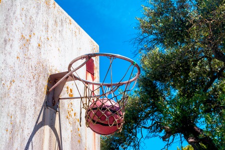 ball inside the basket in an old country playgroundの写真素材