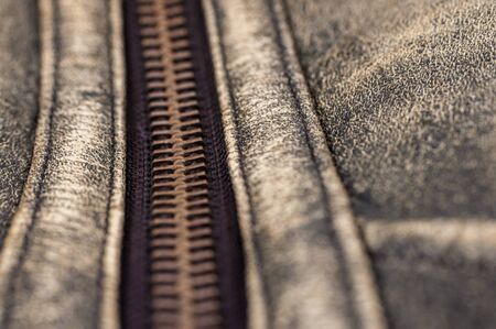 macro of zipper on light brown leatherの写真素材