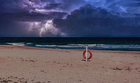 beach during the storm with lightning and dramatic cloudy skyの写真素材
