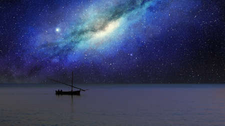 fishing boat sails under the milky way at nightの写真素材