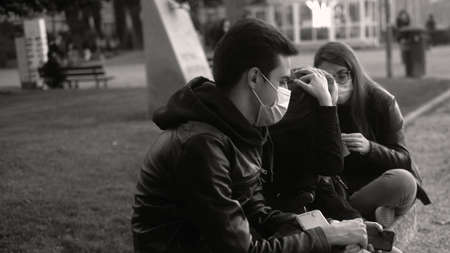 LECCO,LOMBARDY, ITALY - 30 october 2020: Group guys chill out at Lecco parkのeditorial素材