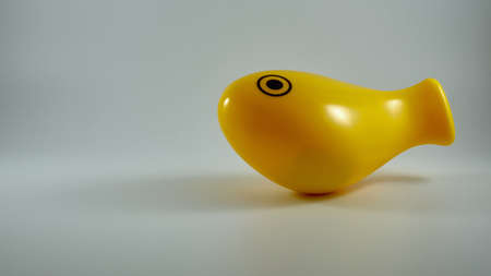 Bath toy fish in yellow plastic on white background. Copy Spaceの写真素材