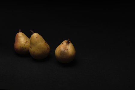Yellow Pears Isolated On Black Background. Copy Spaceの写真素材