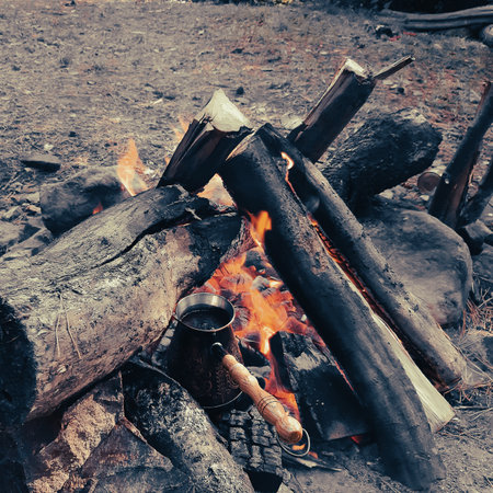 Brew coffee in a Turk on an open fire.の写真素材