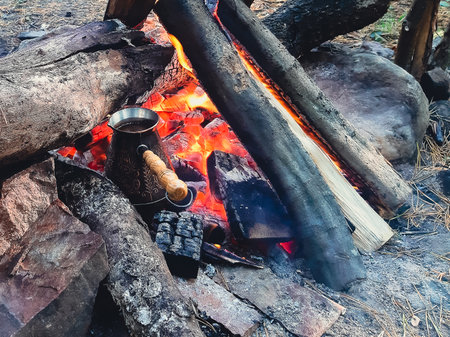 Brew coffee in a Turk on an open fire.の写真素材