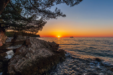 Amazing sunset with endless horizon and lonely figures in the distance Croatiaの写真素材