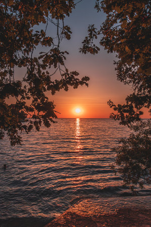 Amazing sunset with endless horizon and lonely figures in the distance Croatiaの写真素材