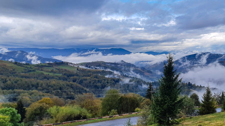 Morning foggy clouds in autumn mountain countryside. Ukraine, Transcarpathia.の写真素材