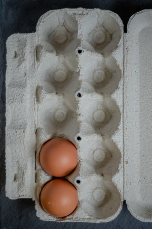 Fresh chicken eggs in a paper tray on the table, selective focusの写真素材