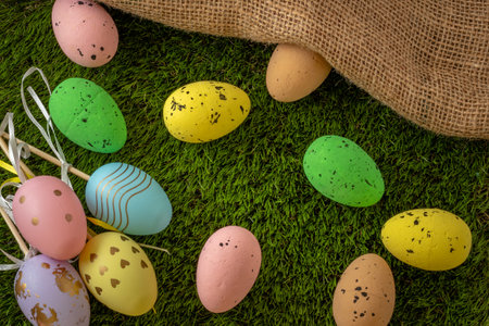 Easter eggs colored on green grass. Congratulations on Easterの写真素材