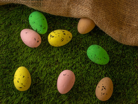 Easter eggs colored on green grass. Congratulations on Easterの写真素材