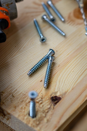 a partially twisted confirmation into a freshly drilled hole in the boardの写真素材