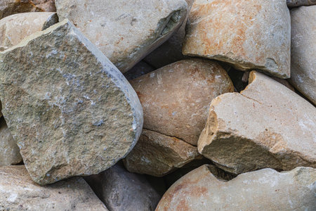 Closeup of smooth river rocks displaying a variety of warm tonesの写真素材