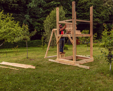 A small playground. Childrens wooden house. Childrens swingの写真素材