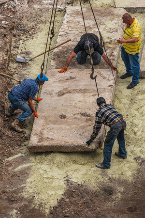 Laying panels on the road near the church Lviv Ukraine 20.05.24