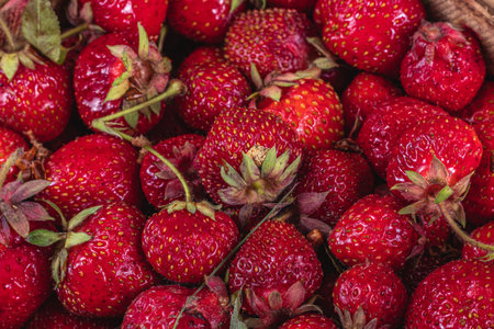 ripe sweet strawberries in wooden wicker box on table top backgroundの写真素材