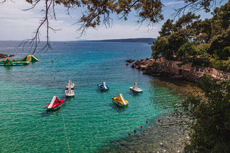 Krk Croatia 26.06.24 Catamarans in a quiet location on the beach in the old townのeditorial素材