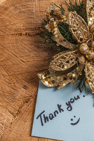 The word thank you for the light of a blue leaf on a piece of woodの写真素材