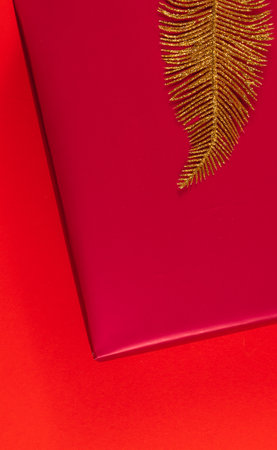 Christmas decoration of leaves on a box on a red background