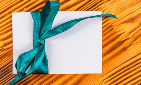 Blank note with green ribbon wooden , conceptの写真素材