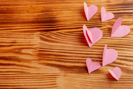 Composition of pink hearts on a wooden backgroundの写真素材