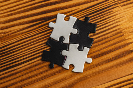 A black and white puzzle piece fit for a concept of yin yang or oppositesの写真素材