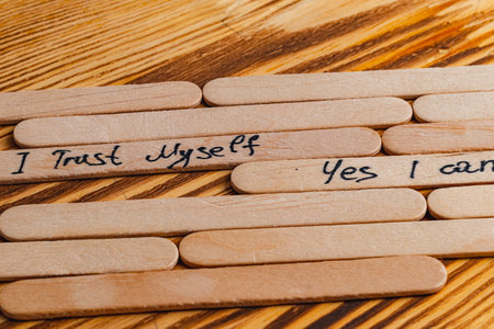 Positive thoughts for increasing selfesteem on wooden posts on wooden backgroundの写真素材
