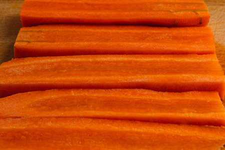 Cut carrots flat slice as background for healthy eating conceptの写真素材