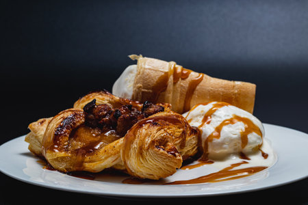 Delicate puff pastry with apples, ice cream and caramel syrup, snack conceptの写真素材