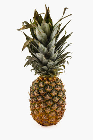 A vibrant, fresh pineapple is displayed against a plain background. The fruit showcases its rough...