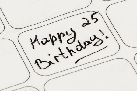 A handwritten note displays a cheerful birthday message celebrating the 25th birthday. The simple design adds a personal touch to the celebration.の写真素材