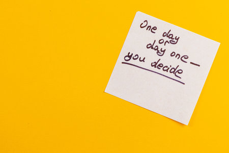 A handwritten note on a bright yellow background encourages reflection, stating that each day offers a choice. The message invites personal decision-making and motivation.の写真素材