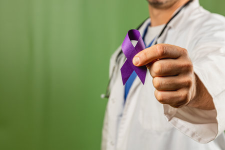 A healthcare professional holds out a purple ribbon in front of a green background. This gesture symbolizes support and awareness for various health issues, showing commitment to the cause.の写真素材