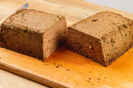 Freshly made chicken liver pate, perfectly sliced and presented on a wooden cutting board. This dish showcases a smooth texture and rich color, ideal for appetizers or spreads.の写真素材