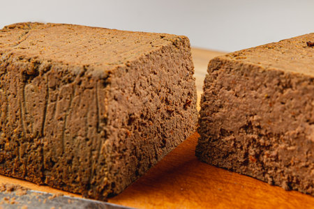 Slices of rich and creamy homemade chicken liver pate rest on a wooden board, ready to be enjoyed. Perfect for appetizers at any gathering or special occasion.の写真素材