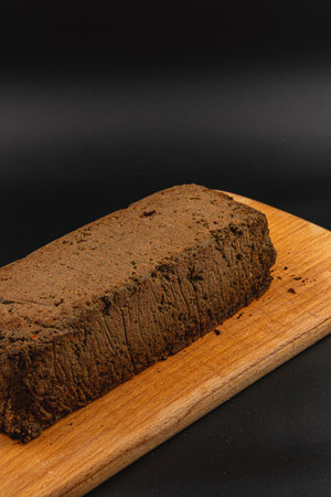 A smooth, homemade chicken liver pate is displayed on a wooden board, ready for serving. The rich texture and deep color highlight the gourmet appeal of this dish.の写真素材