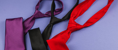 Selection of elegant ties in purple, black, and red colors suitable for Father's Day and birthdays. Perfect gifts that convey appreciation and style, highlighting men's fashion choices.の写真素材