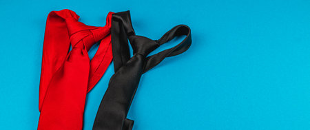 Ties in black and red set against a bright blue background. Ideal gifts for Father's Day or birthdays, conveying love and appreciation for fathers during special celebrations.の写真素材