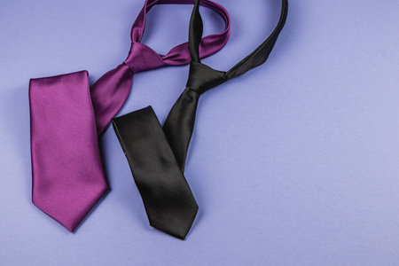 Various ties in purple and black are arranged on a vibrant background, perfect for a Father's Day gift or birthday celebration, focusing on thoughtful choices for men.の写真素材