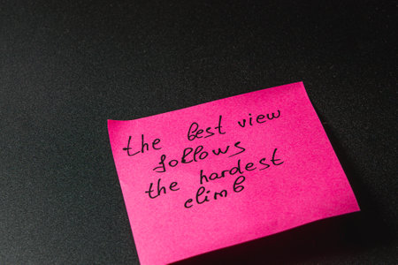 A pink sticky note displays an inspiring message about overcoming challenges. The handwritten words...