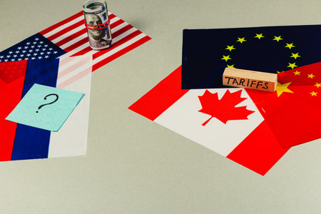 Flags of the US, Canada, China, Russia, and the EU symbolize complex political dynamics involving trade, tax, and tariffs during ongoing global negotiations.の写真素材