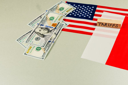 Currency and flags illustrate trade tensions, showcasing the USA's economic stance on tariffs, impacting politics and commerce amid ongoing negotiations.の写真素材